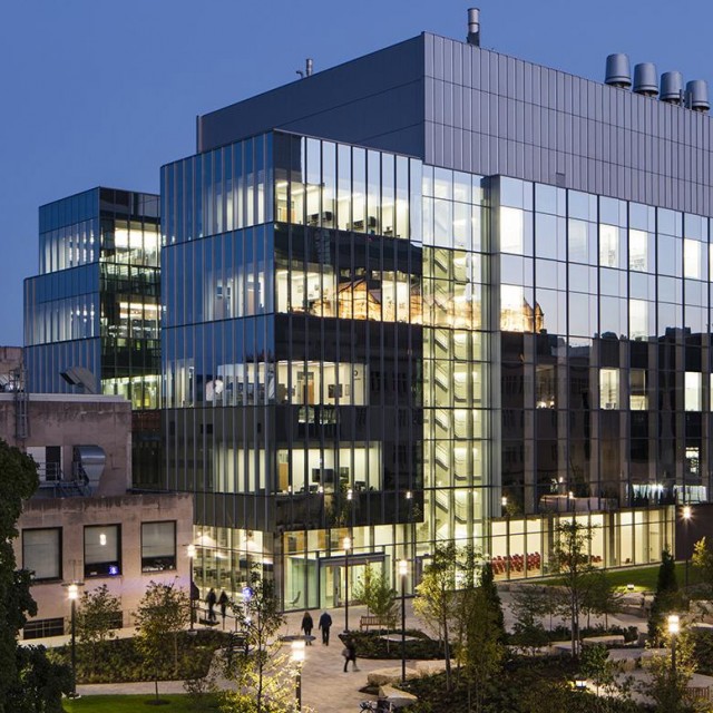 Southeasterly view of the illuminated Eckhardt Research Center in the evening